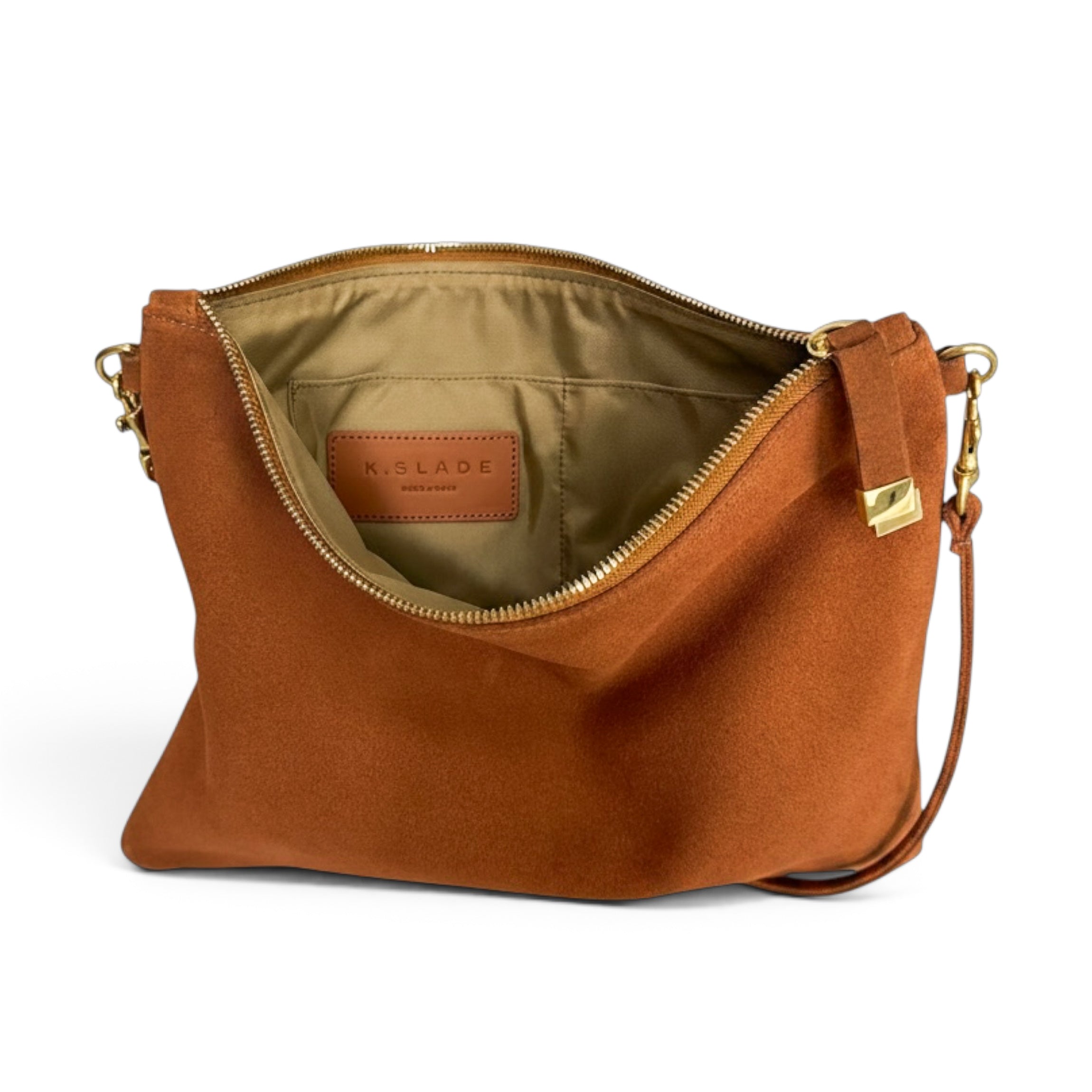 A Kislade cognac brown suede shoulder bag shown open to reveal a tan interior lining and gold-tone hardware, set against a plain white background.