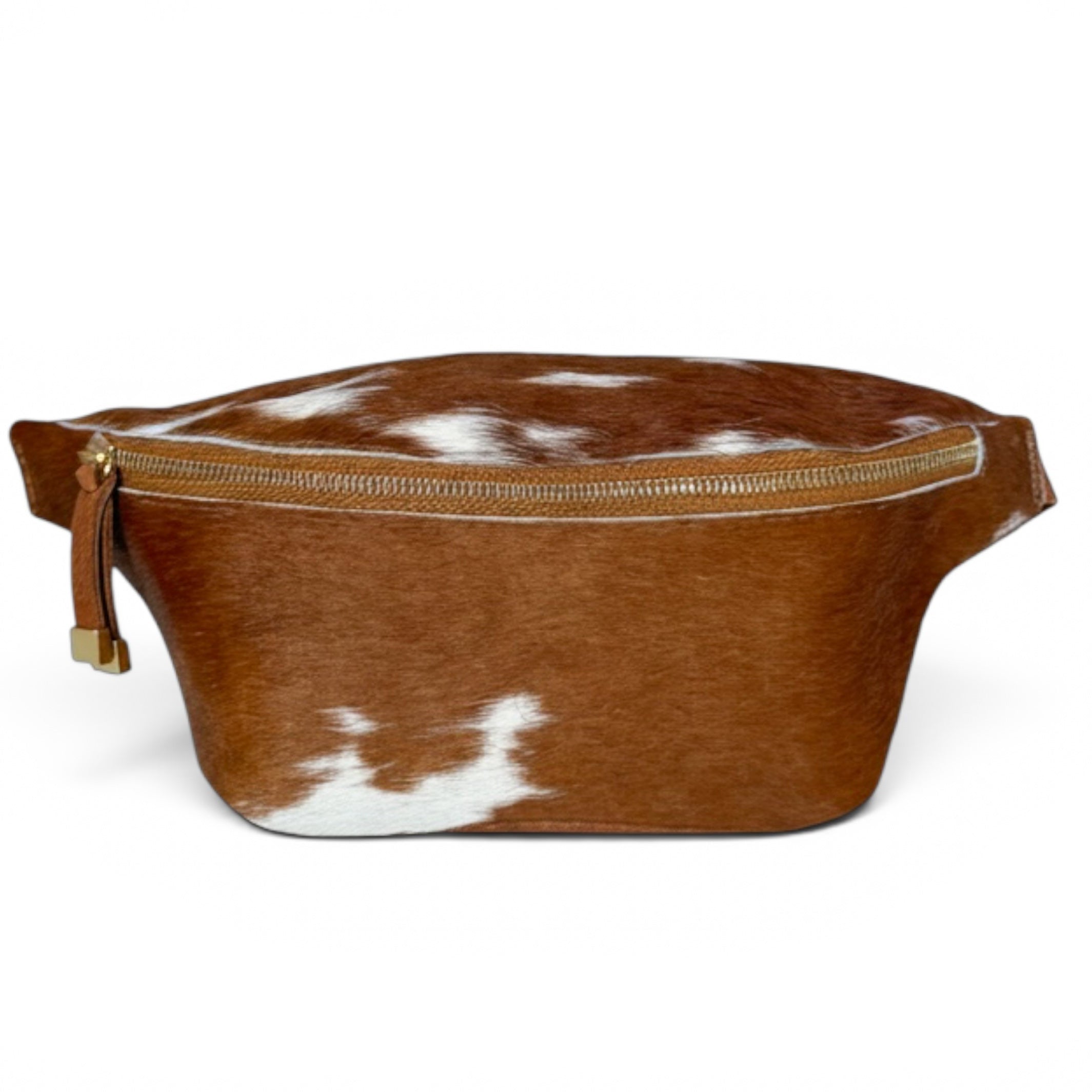 A brown and white cowhide belt bag with a gold-tone zipper and a leather pull tab, shown on a plain white background.